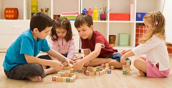 kids doing building blocks on floor