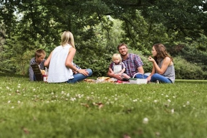 a family have a picnic in a park