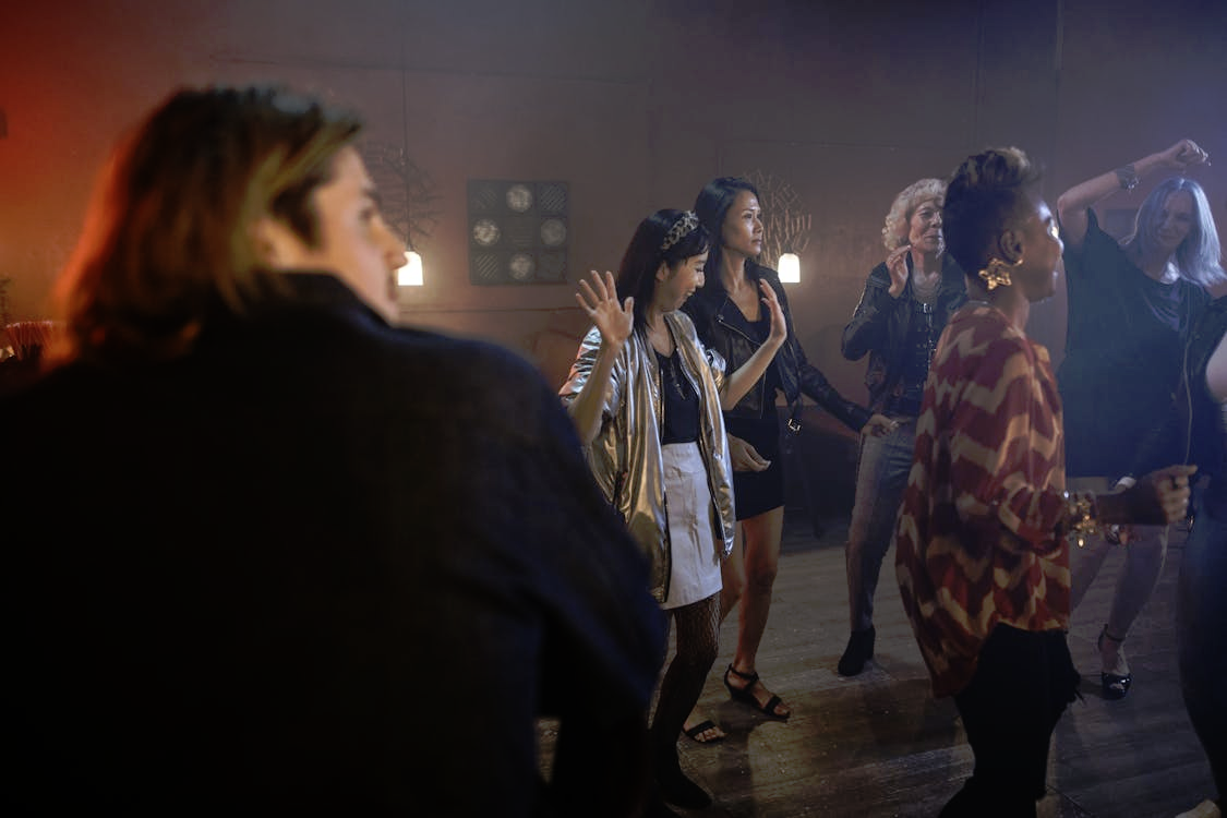 Group of family members of various ages dancing at a party venue