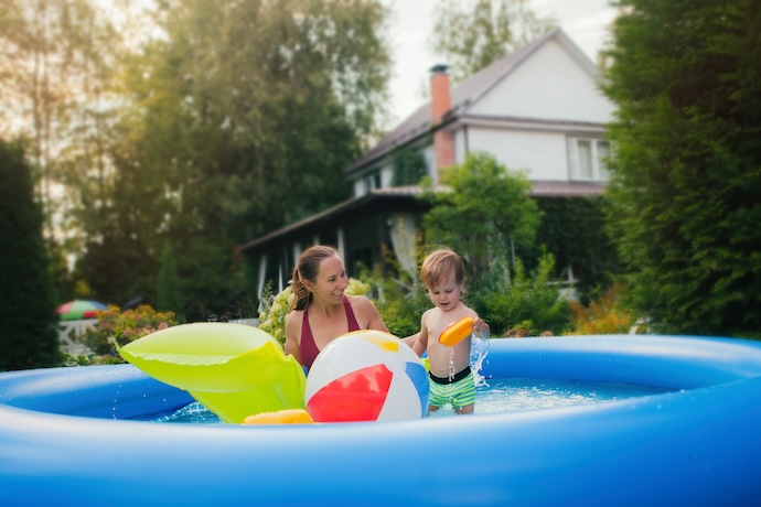Mother and child playing in inflatable pool