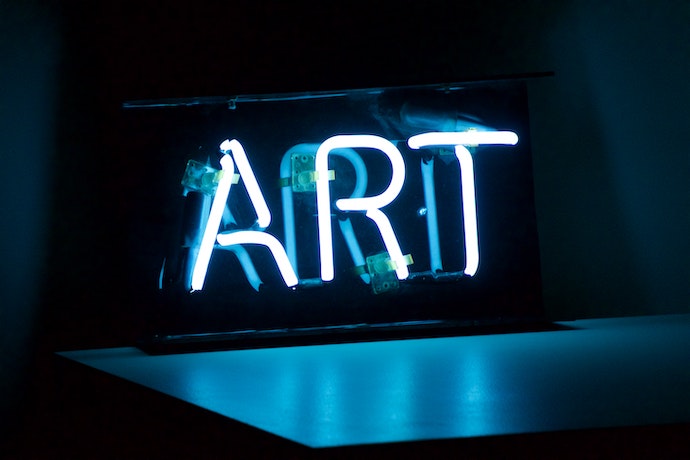 a neon display saying ART