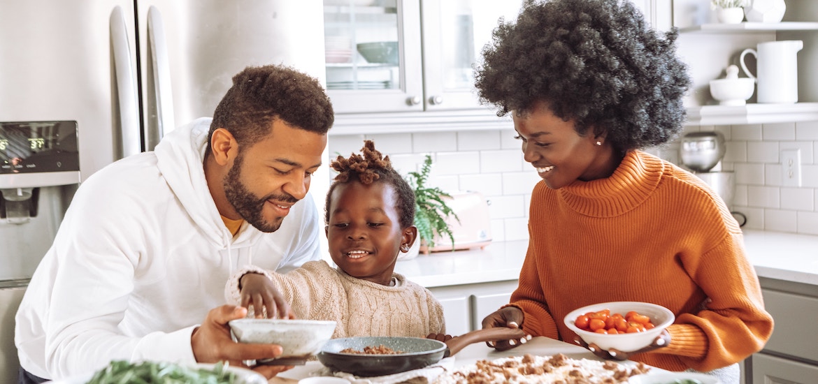 a young family enjoy cooking together