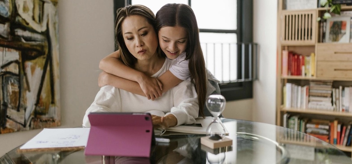 woman with girl on laptop