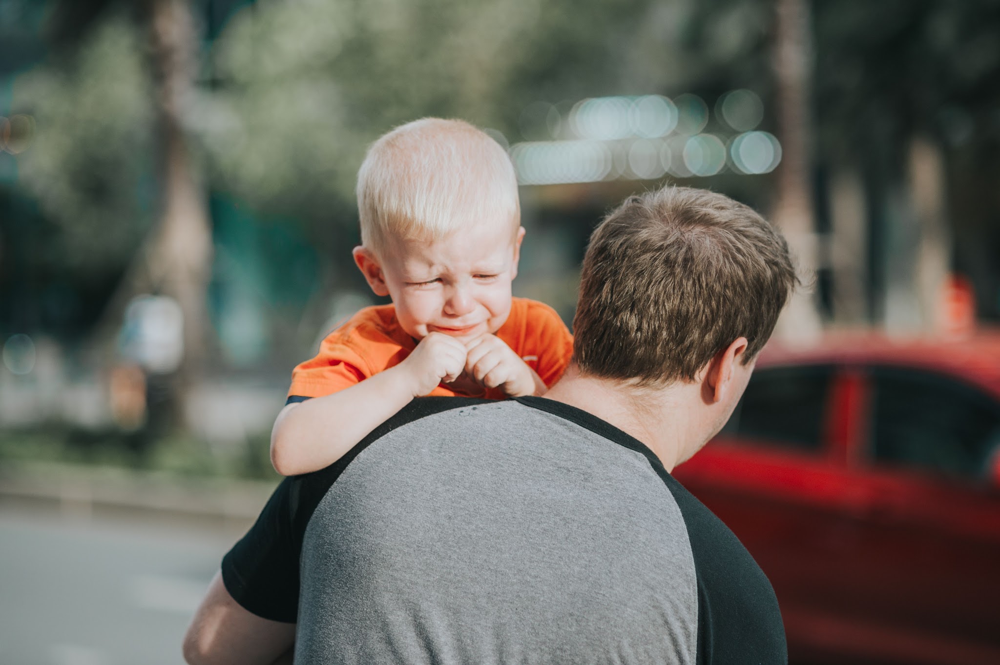 dad comforting crying son