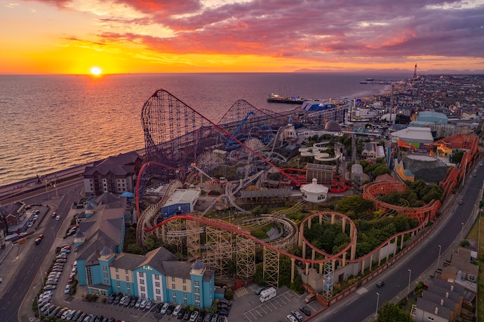 wide shot of Blackpool Pleasure Beach at sunset