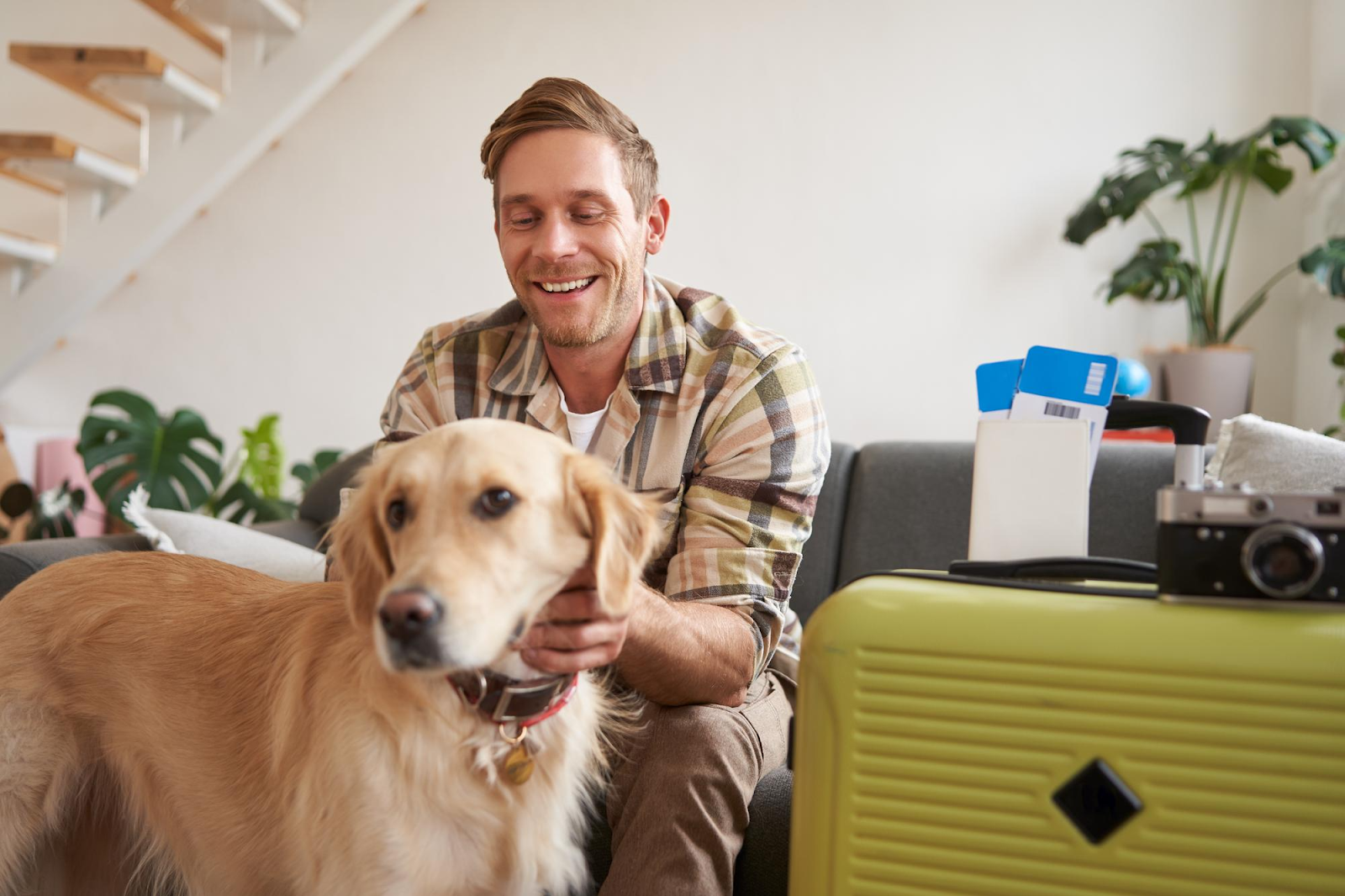 man plays with his dog at home