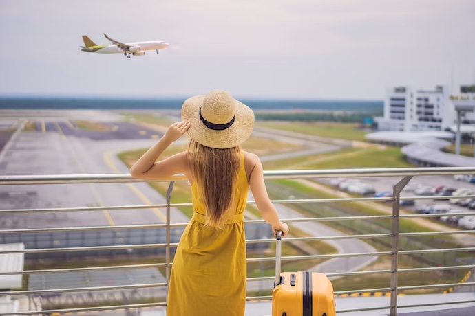 woman watches plane takeoff