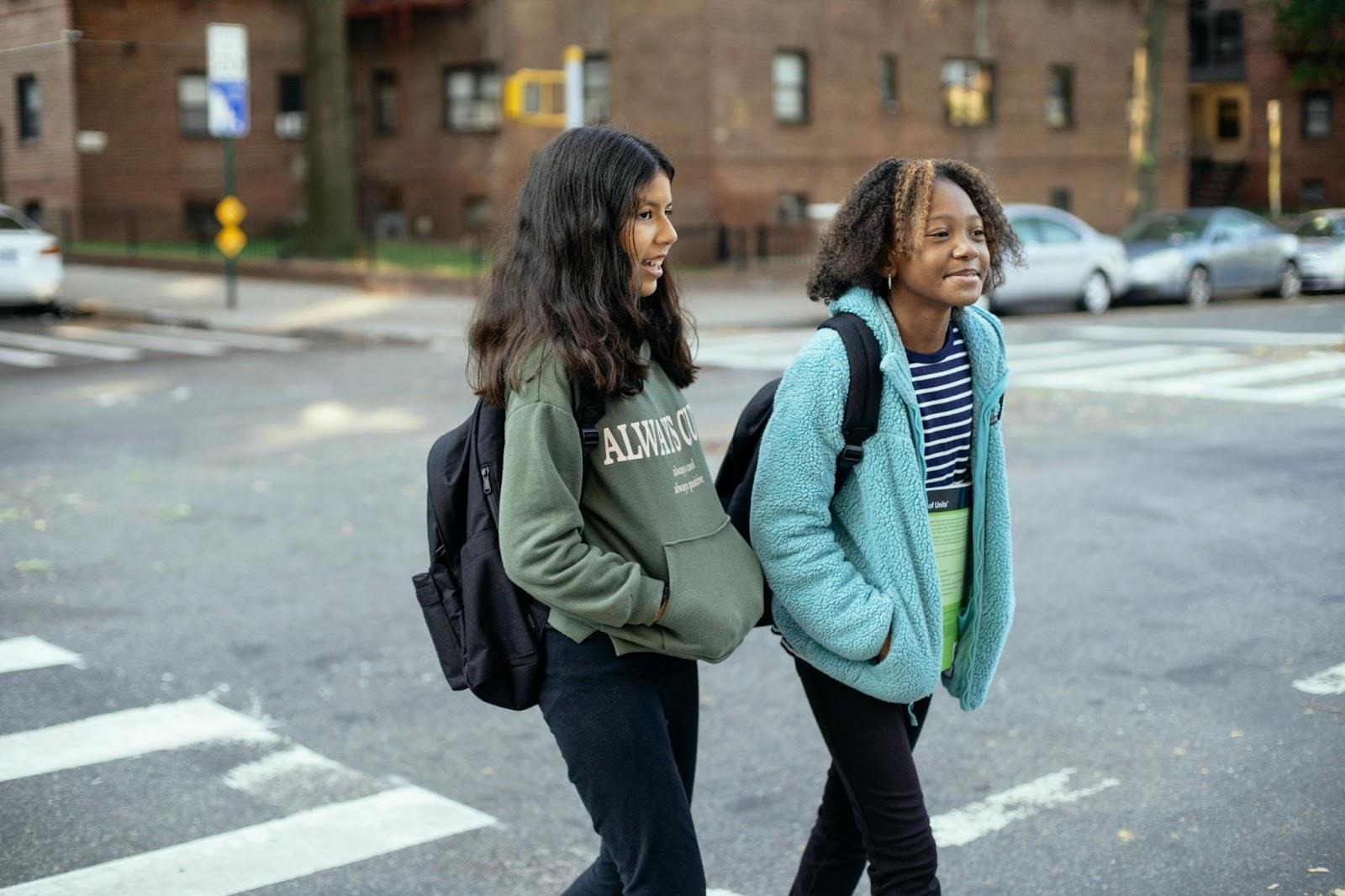Schoolgirls cross road