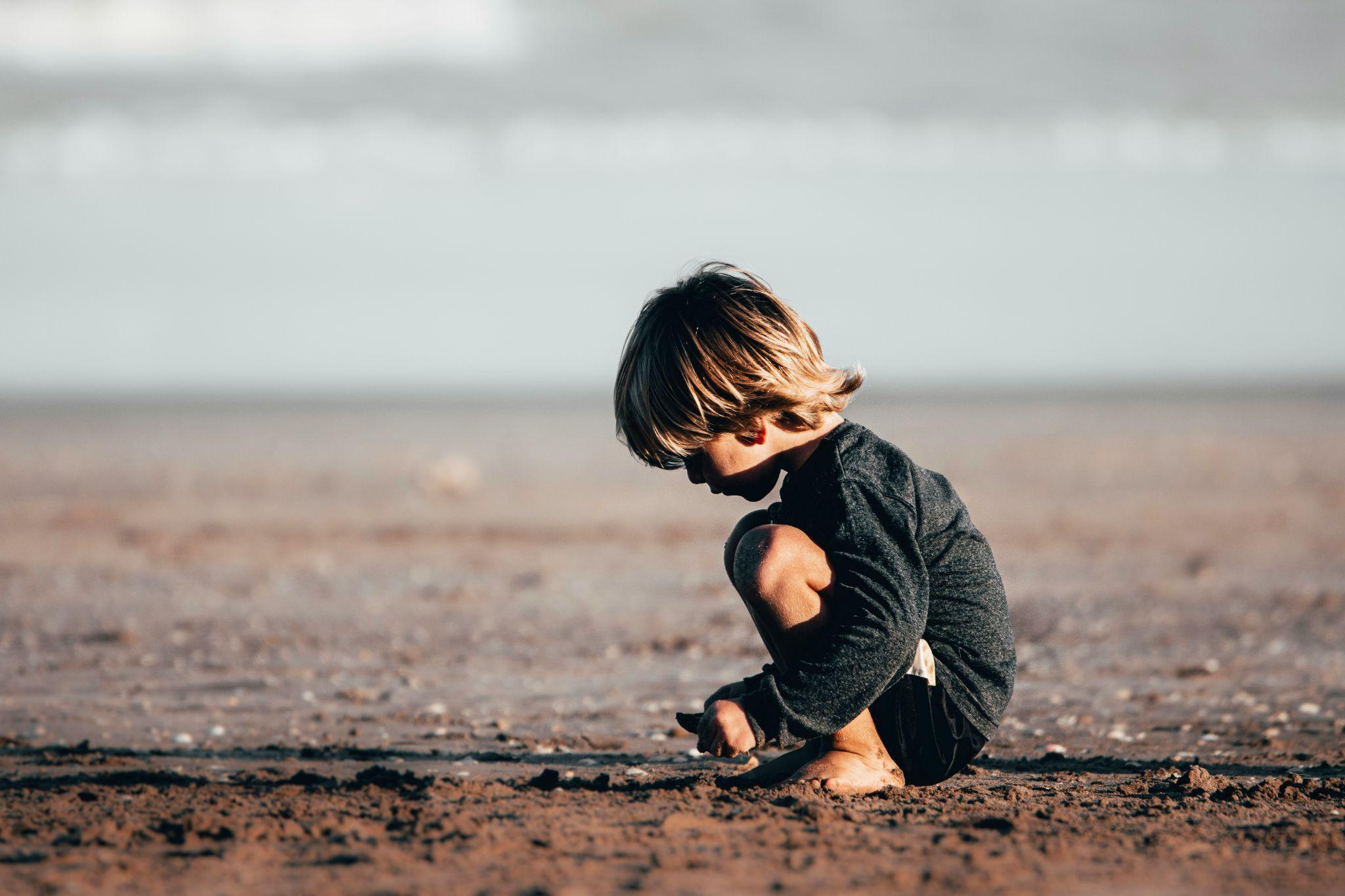 kid playing in the sand