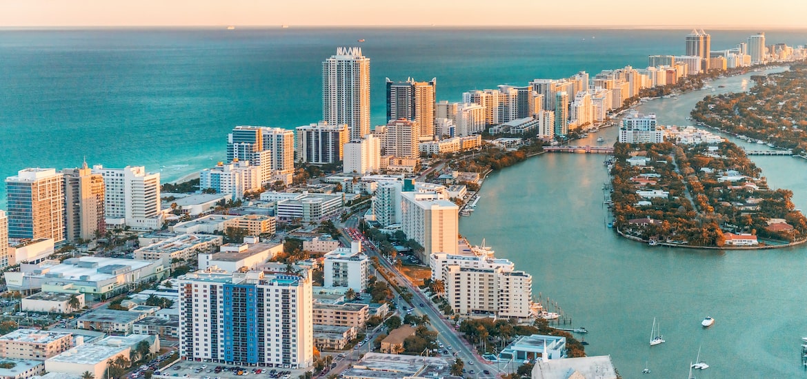 miami, florida, skyline over Miami at sunset with water and buildings