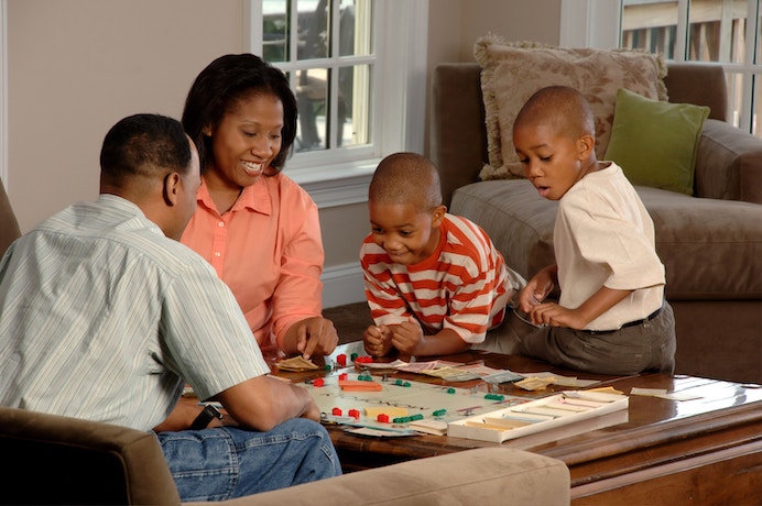 a family enjoy a board game