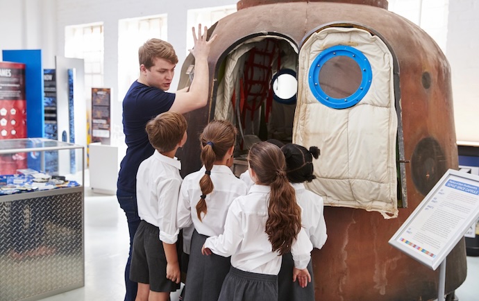 a teacher explains at a science museum