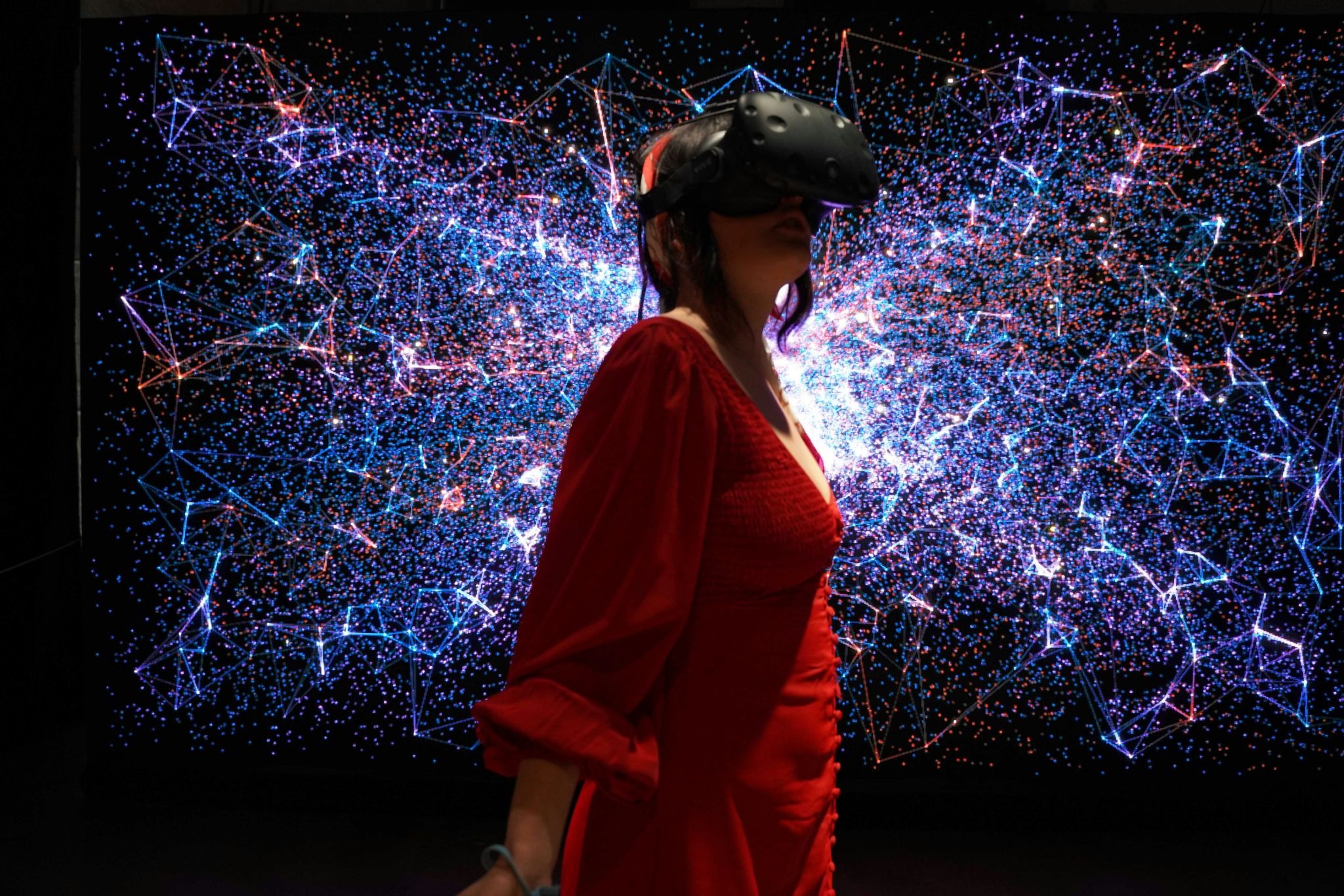 Woman in a red dress exploring a VR museum