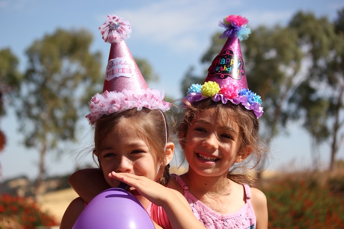 little girls in birthday hats