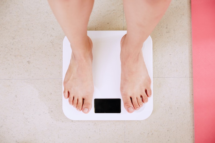Female feet on the scales