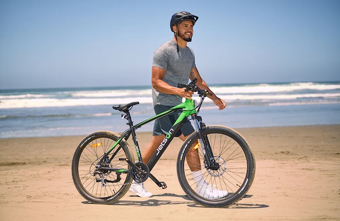 man with mountain bike on beach