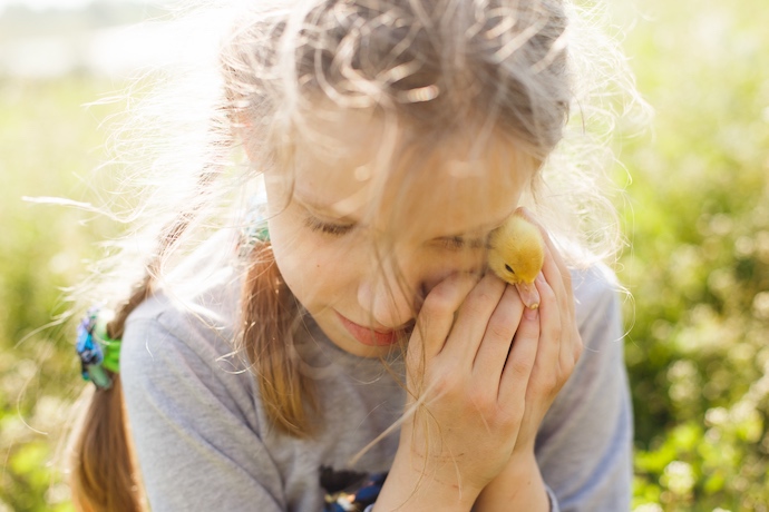 girl with baby duck