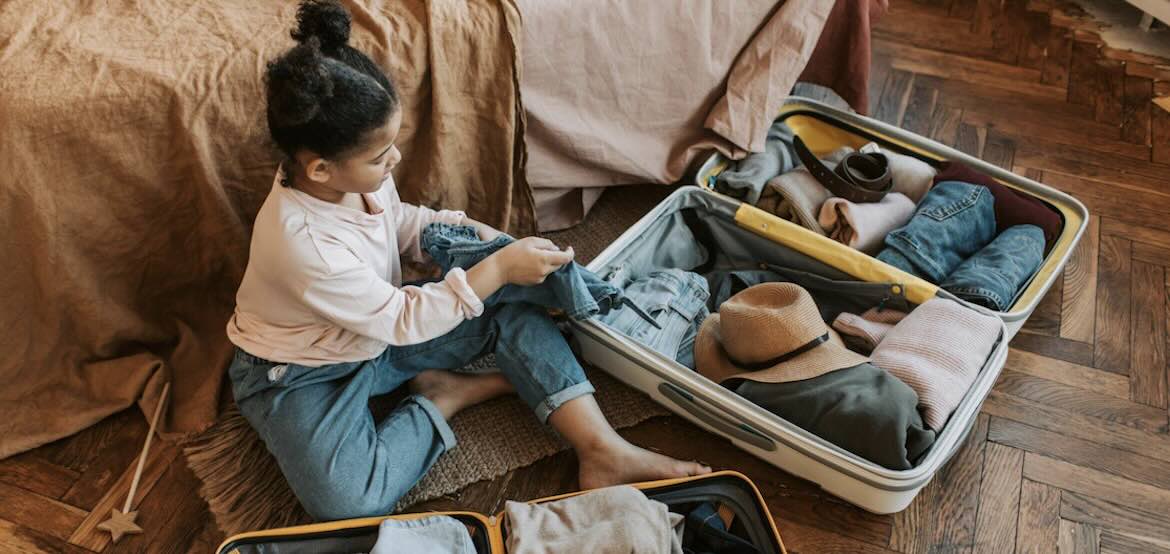 Young girl packs bags