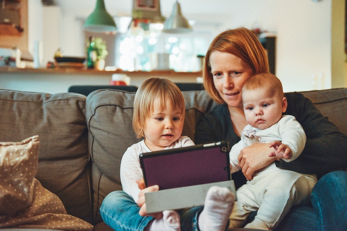 a mother and two small children on a tablet
