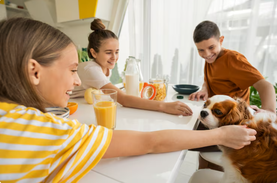 family with dog at dinner table