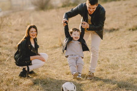 dad and mum playing with toddler