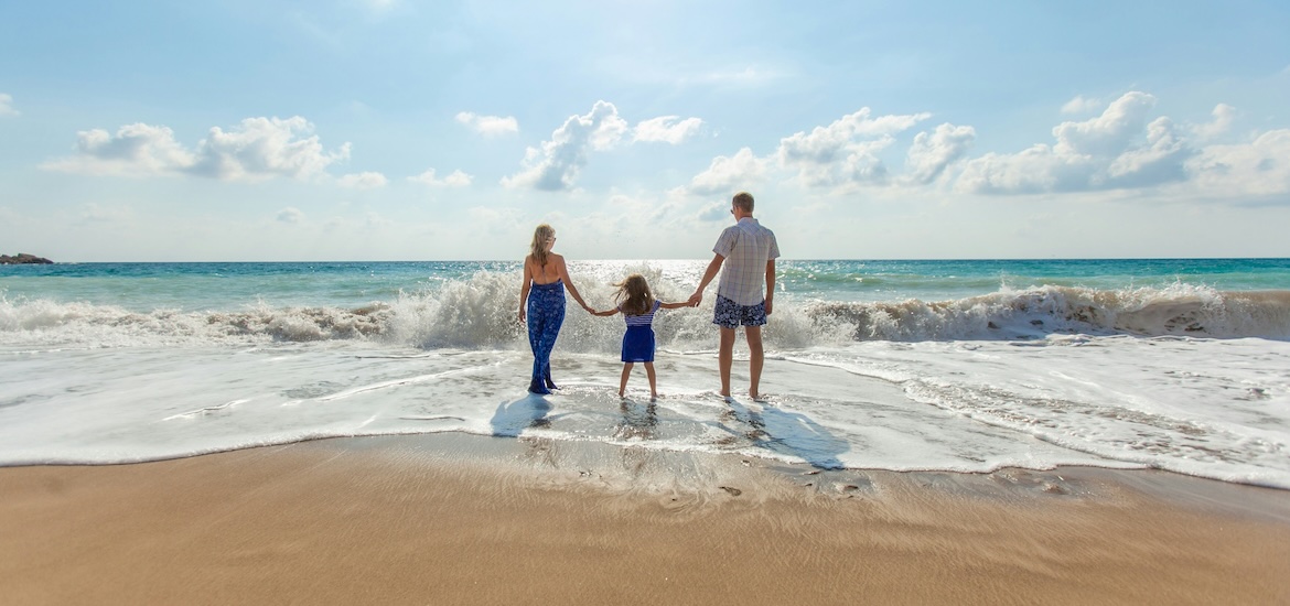 Family on beach near water