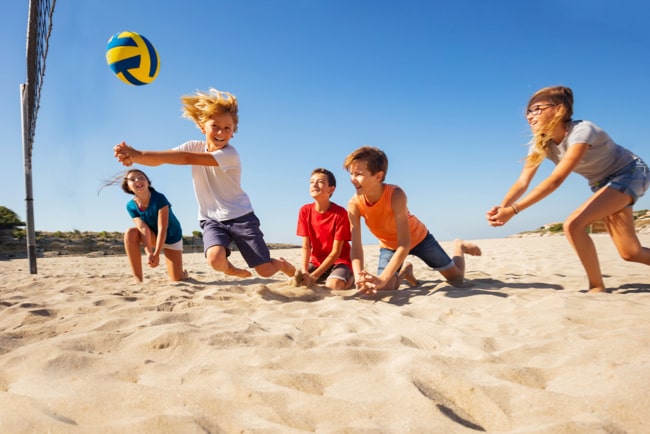 Kinds Playing Volleyball at the beach