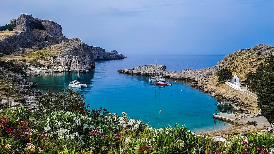 A body of water with boats and rocks