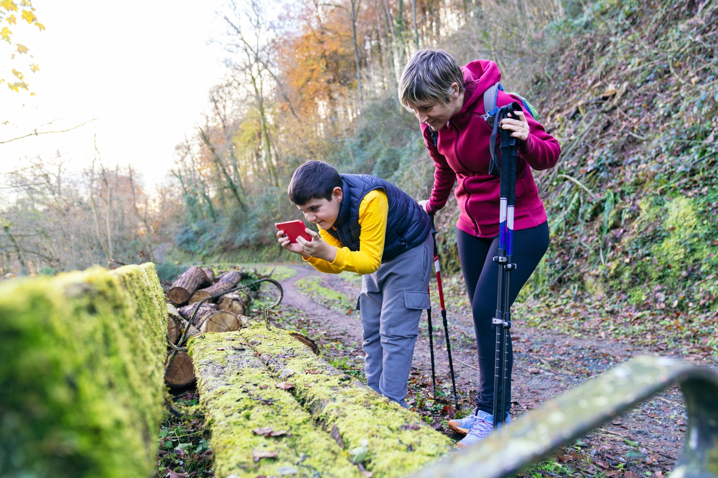 Mom and son taking photos in nature