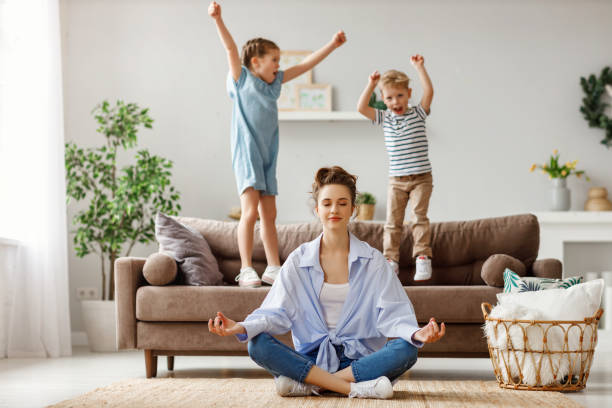 mum meditating as kids go crazy around her