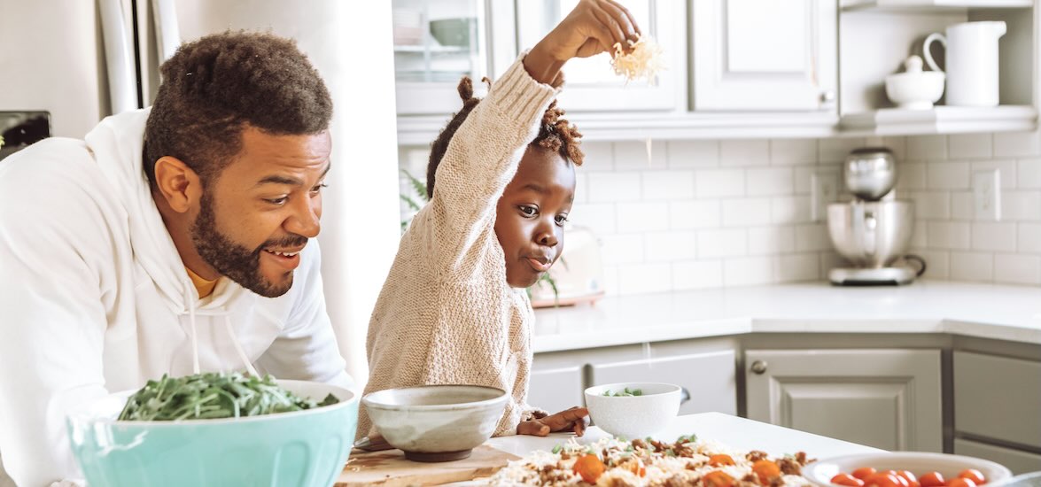 Family making homemade pizza together for National Pizza Day