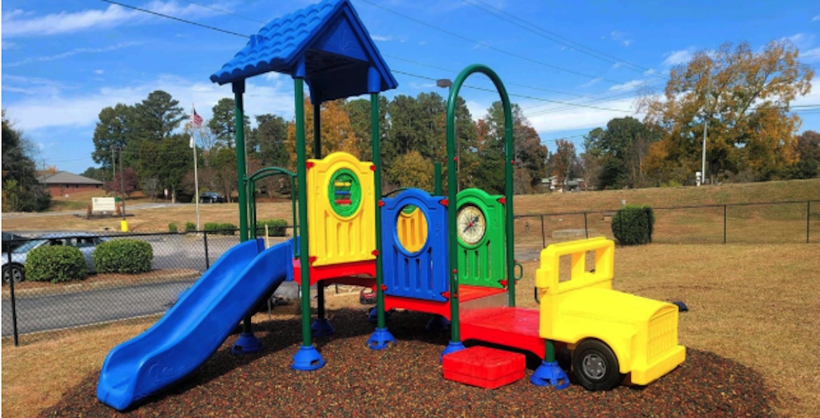 Colorful preschool playground with slide and truck
