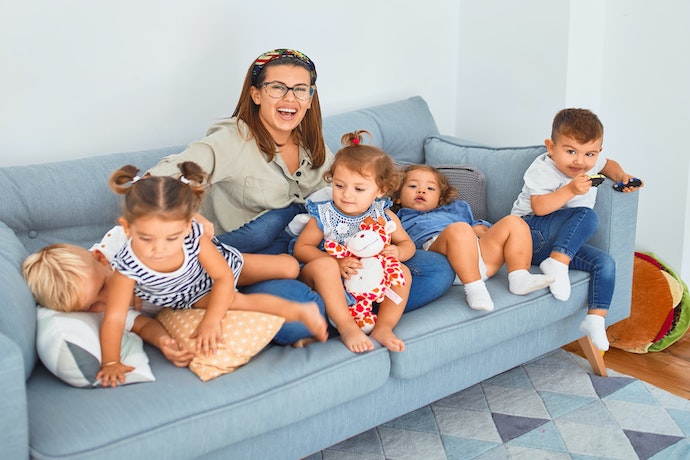 a mom and kids play on the sofa
