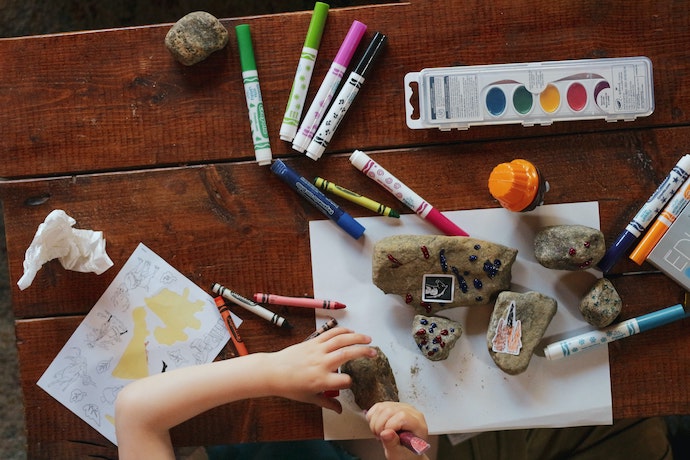 a kid painting rocks