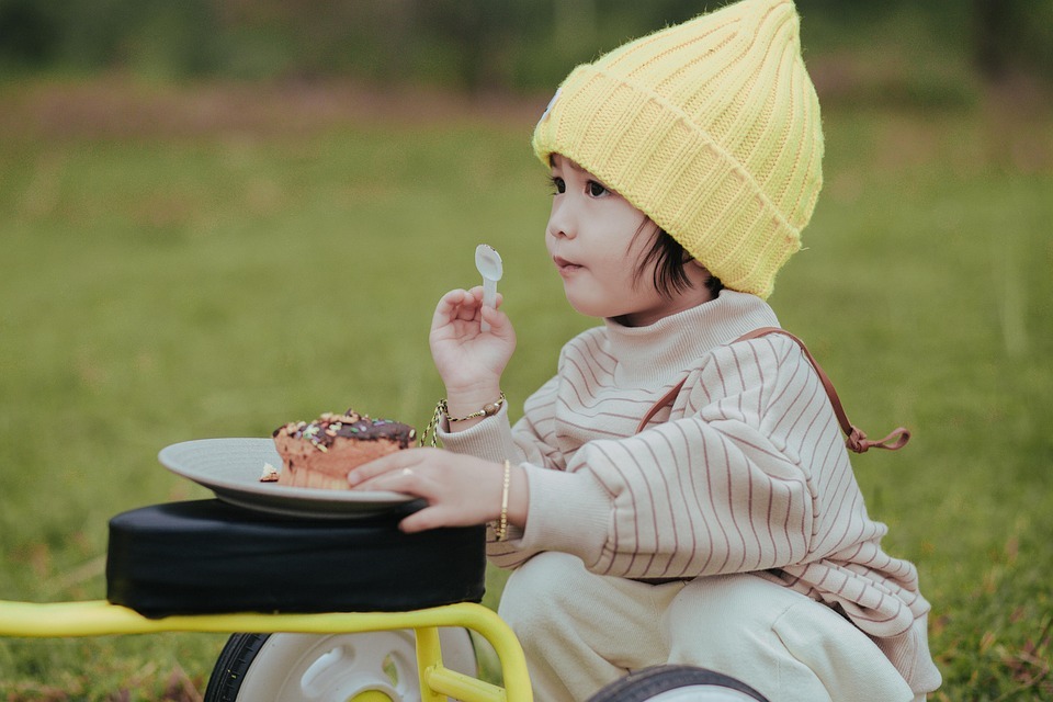 a boy blowing bubbles on a picnic