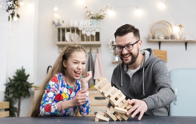 father and daughter play blocks
