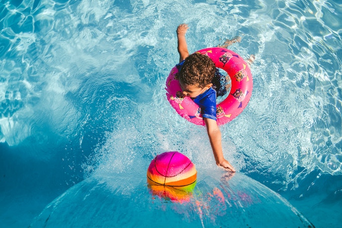 toddler in the pool in a rubber ring