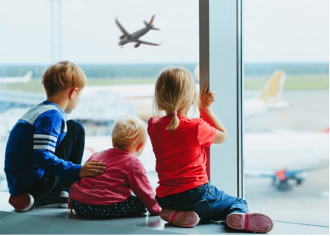 Kids waiting for plane in airport for family travel