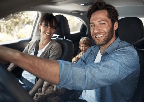 Family driving in a car on a roadtrip