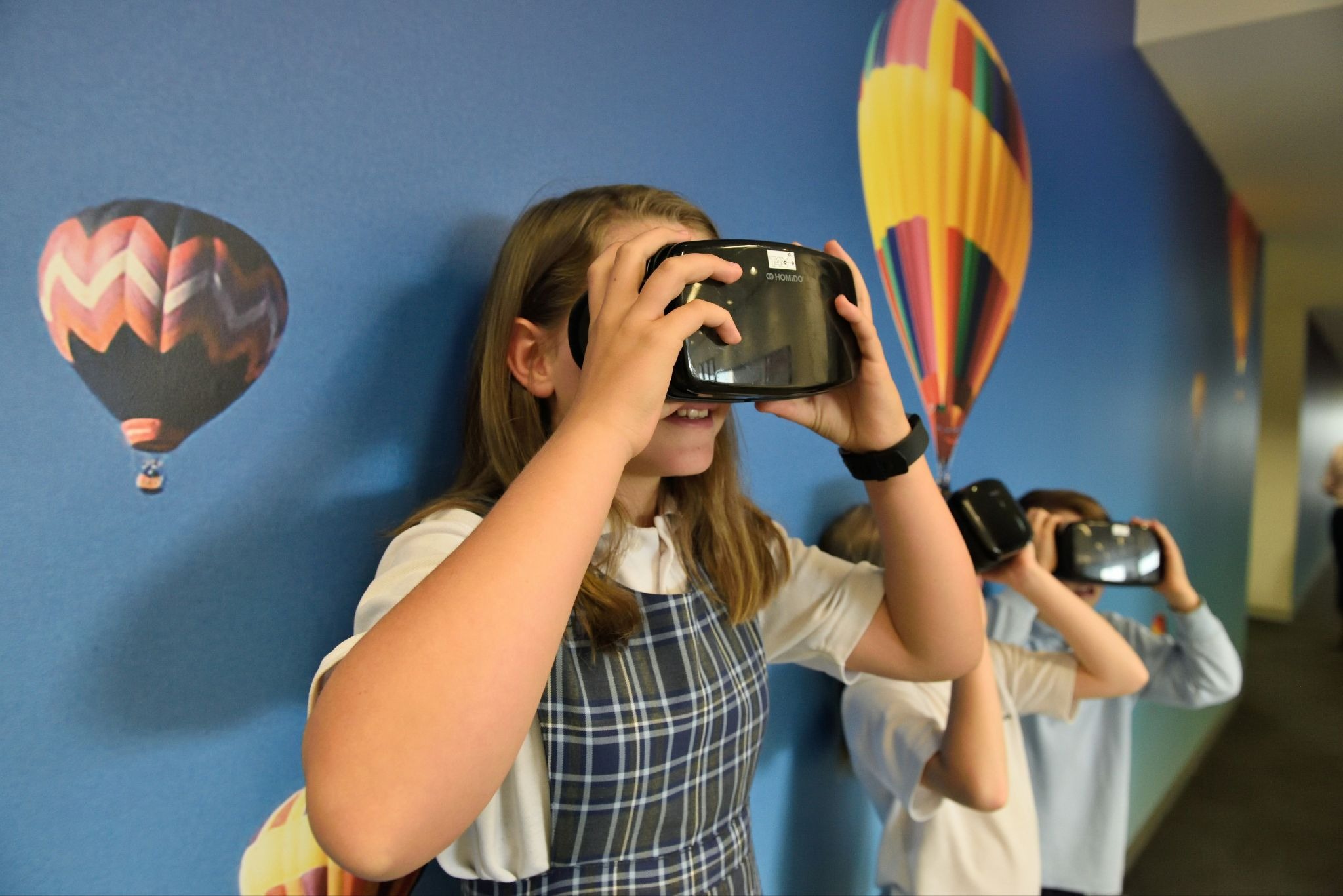 Children wearing VR headsets