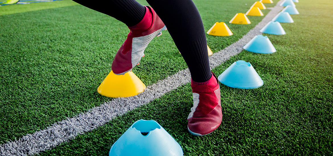 Close up of feet working in training soccer cones