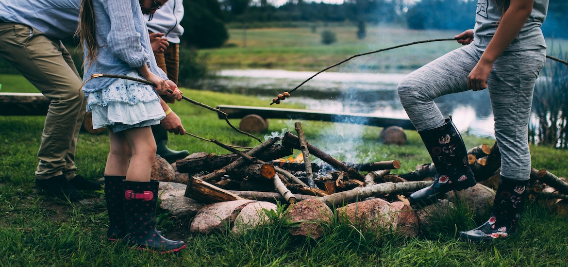 Family camping around camp fire