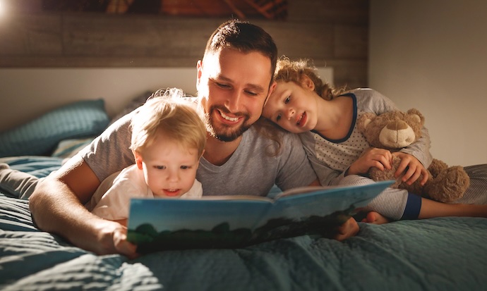 dad reads bedtime stories to kids