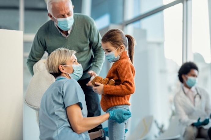 nurse with adult and child in masks