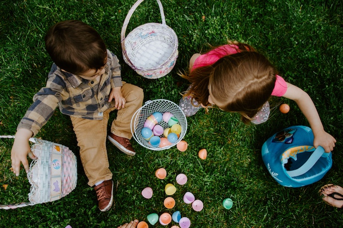 a boy and girl collect Easter Eggs
