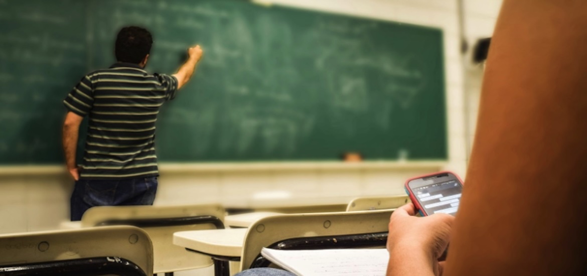 teacher at chalk board