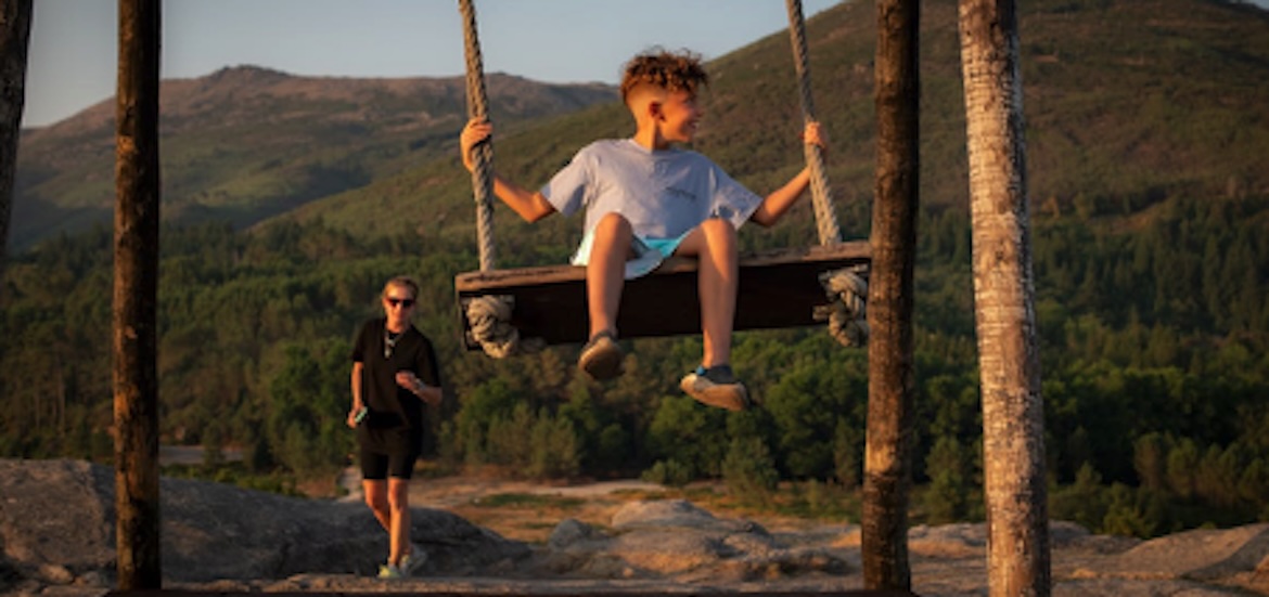 A kid enjoying the swing outdoors