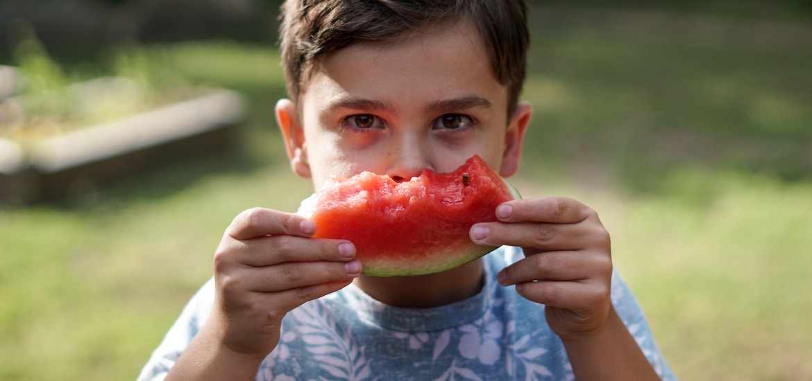 young boy eating watermelon family day out blog encouraging healthy eating in children