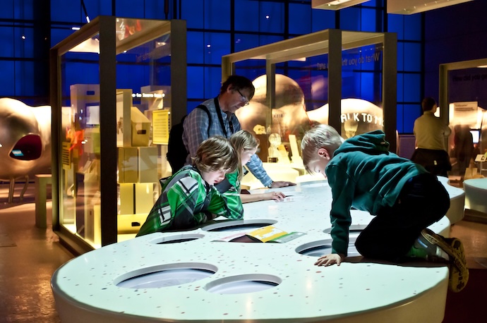 science museum exhibit with kids playing