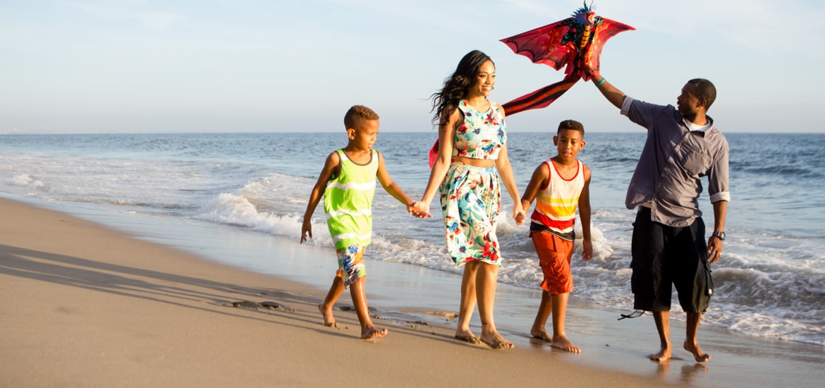 Family walking down the beach in Los Angeles